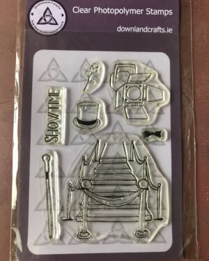 Showtime stamp set with a large roped off stairs stamp, a cane stamp, a stage light stamp,  a rose stamp, a top hat stamp, a bow tie stamp and a sentiment stamp. The word reads 'Showtime